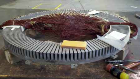 Stator core half-way filled with new windings.